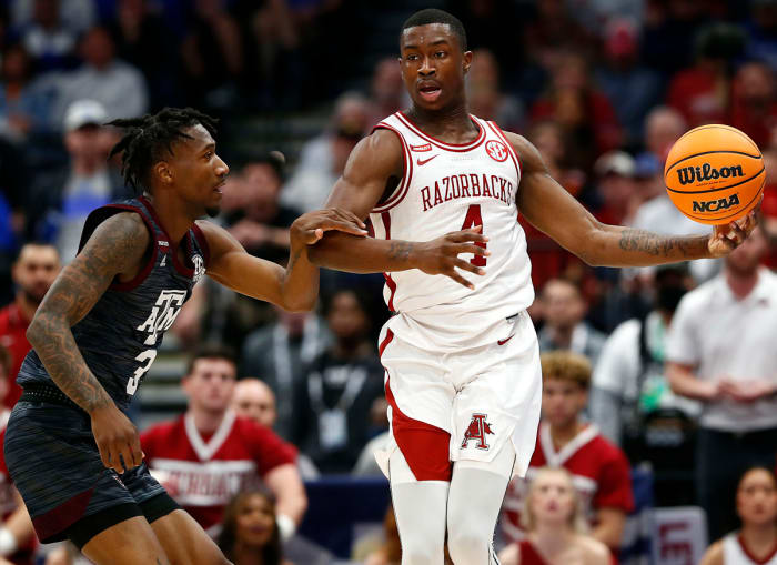 Arkansas guard Davonte Davis loses control of the ball while working against Texas A&M guard Quenton Jackson.